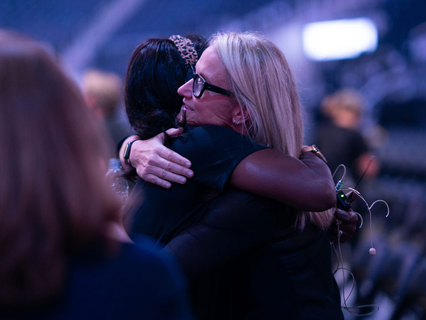 Mel Robbins hugging somebody in production setting