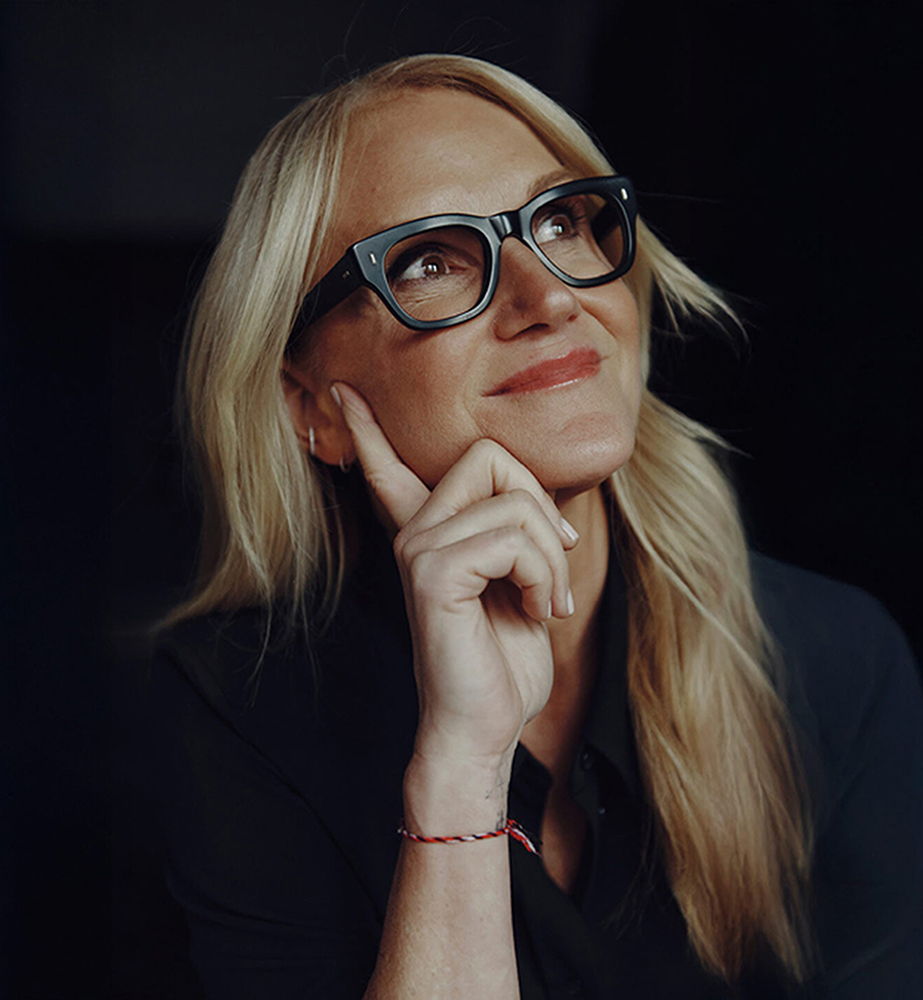 Mel Robbins black background pensive expression