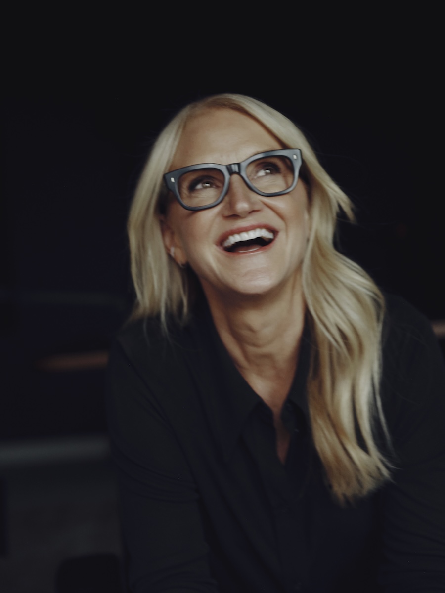 Mel Robbins smiling on black background